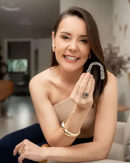 Dra. Helen Daniel segurando um alinhador Invisalign